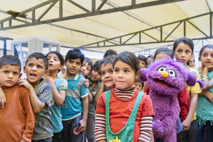 Children gather with muppets 