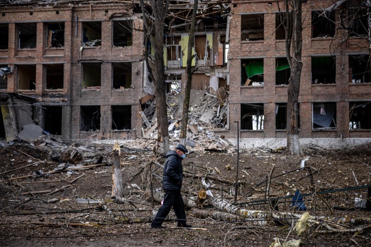 A man walks in front of a destroyed building after a Russian missile attack near Kyiv.