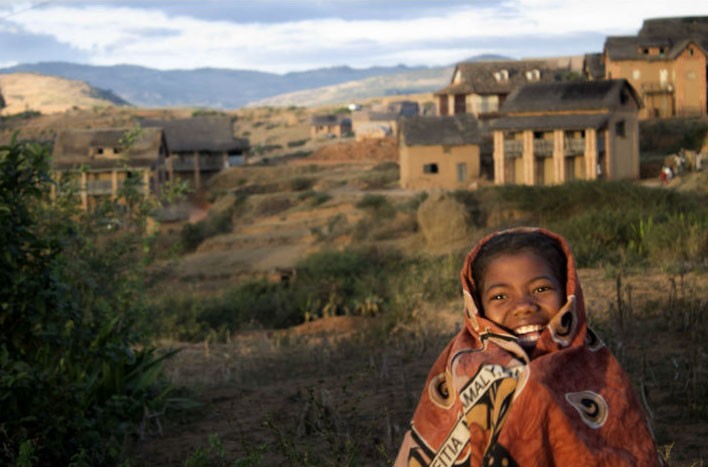 Child wrapped in traditional blanket