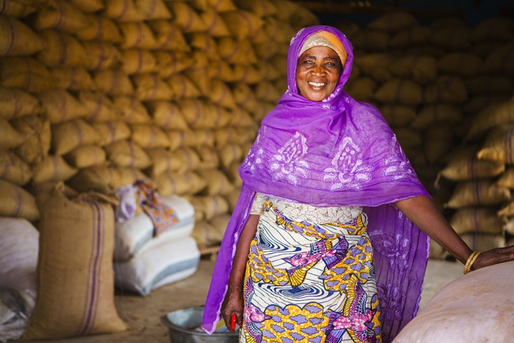 Photo of a smiling woman standing in a warehouse 