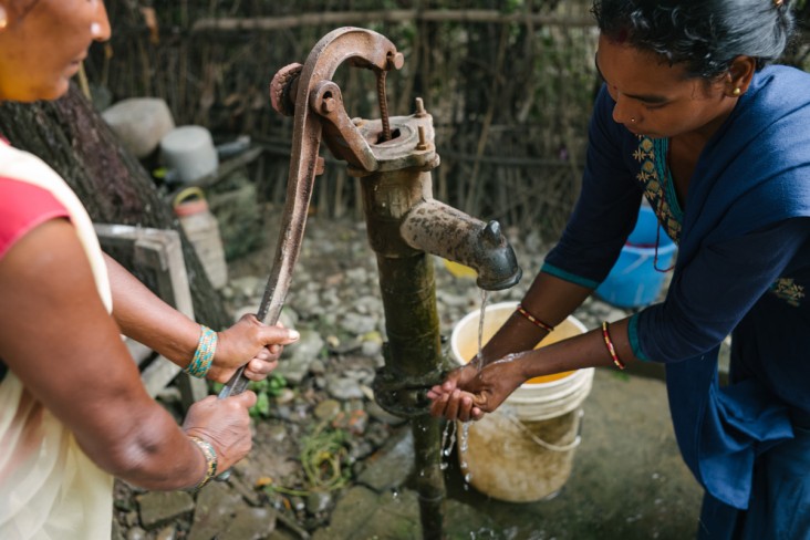 Bimala Chaudhary practices proper hand washing before preparing a meal for her 10-month-old daughter.