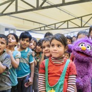 Children gather with muppets 