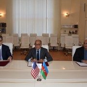 Head of AZPROMO Yusif Abdullayev (left), USACC Board Chairman Reza Vaziri (center), and USAID Mission Director Jaidev Singh (right) sign the agreement.