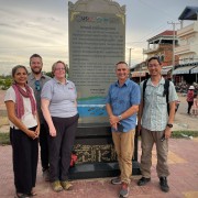 Team in front of fishing plaque 