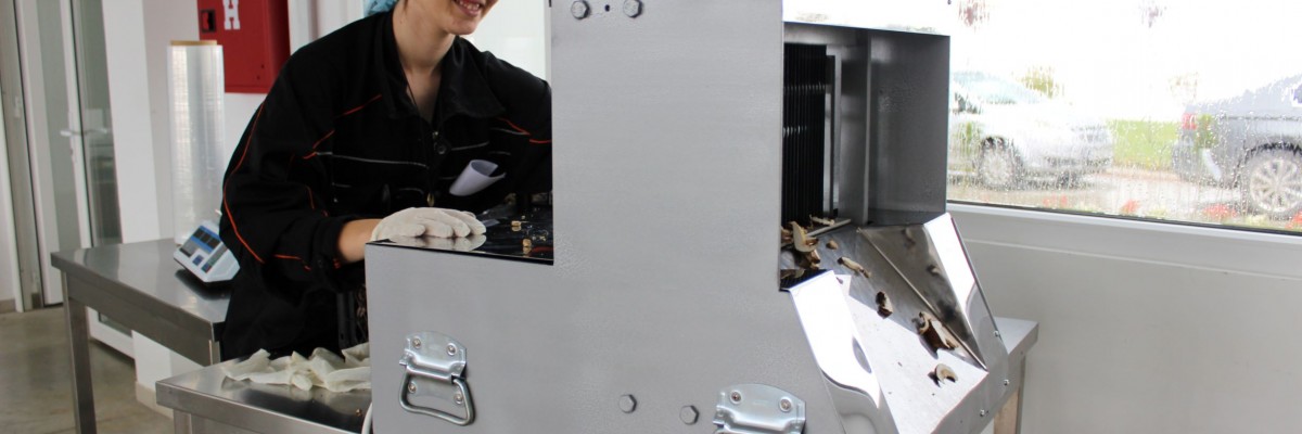 A woman works on an industrial machine